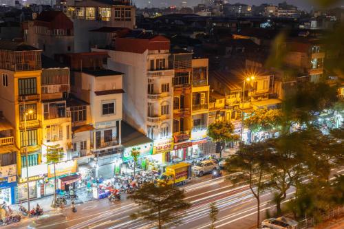 a city street at night with cars and lights at Veshia Hotel & Spa in Hanoi