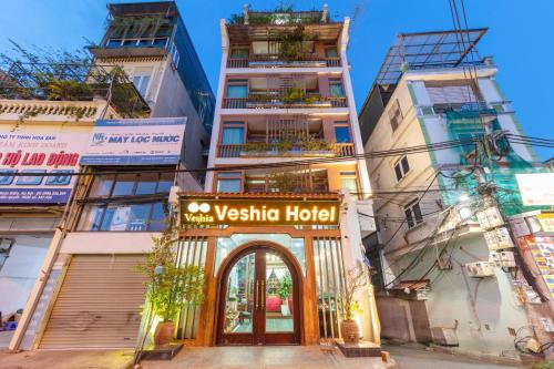 a building with a sign for a vesta hotel at Veshia Hotel & Spa in Hanoi