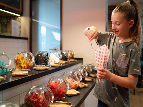 a young girl is looking at glass ornaments at Apartments in the holiday and leisure park Weissenhäuser Strand, Weissenhäuser Strand in Weissenhäuser Strand