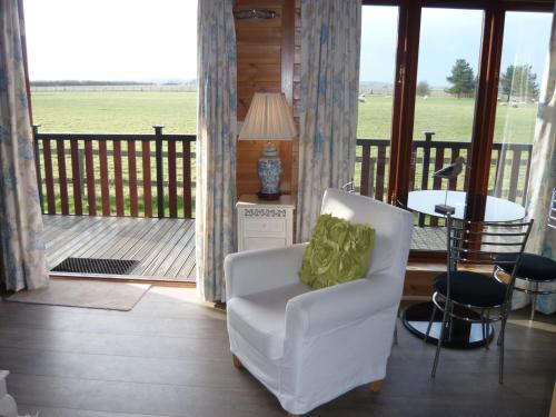 Posezení v ubytování Spacious cottage with sauna looking out on astonishing grasslands