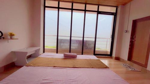 a large room with a large window with a view at The Lake Heaven in Mirik