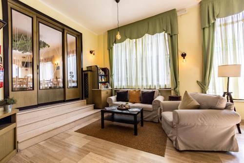 a living room with two couches and a coffee table at Hotel La Chance in Saint Vincent