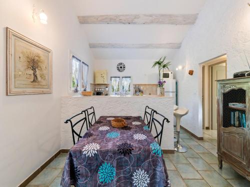 a dining room with a table and chairs at Modern holiday home with private pool in Lambesc