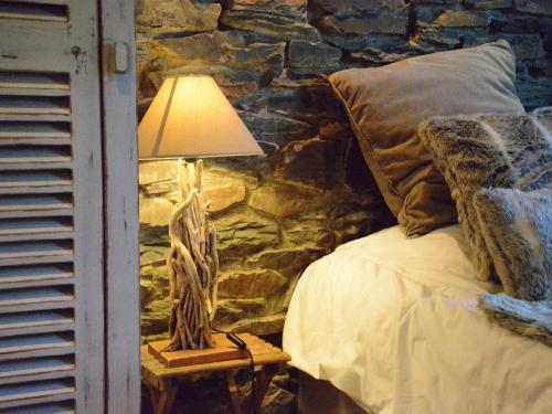 a lamp sitting on a table next to a bed at Cottage with Foosball & Garden in Jehonville