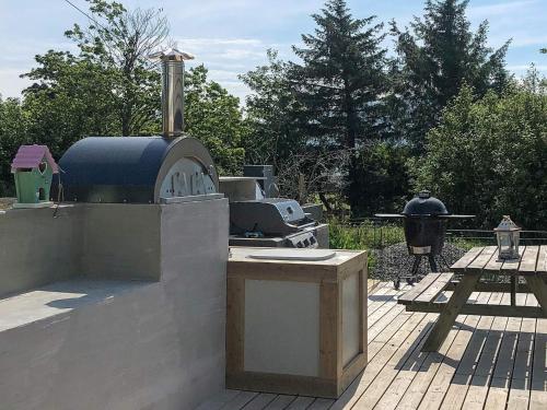 a outdoor kitchen with a stove on a patio at 10 person holiday home in Tornes I Romsdal in Tornes