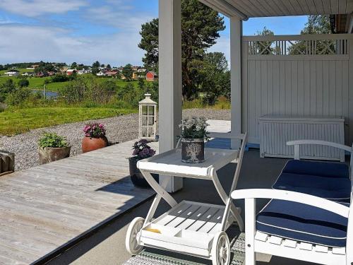 a patio with two chairs and a table on a porch at 10 person holiday home in Tornes I Romsdal in Tornes