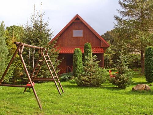 a playground in front of a house at Authentic Holiday Home in Kopalino with Fireplace in Kopalino