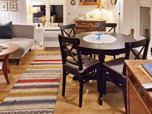 a dining table and chairs in a living room at 7 person holiday home in Skutvik in Skutvika