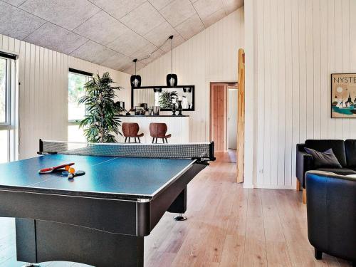 a living room with a ping pong table in it at 18 person holiday home in Væggerløse in Marielyst