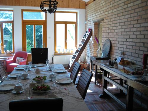 a dining room with a long table and chairs at Mala Kmetija in Slovenske Konjice