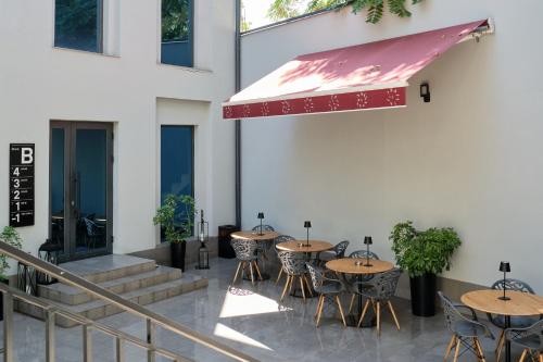 a row of tables and chairs outside of a building at Sapiens Hotel in Tashkent
