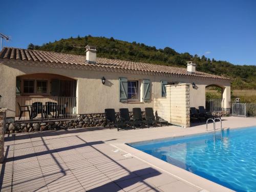 a house with a swimming pool in front of a house at Holiday Home in Toulon with Pool & Beach Nearby in Les Vans