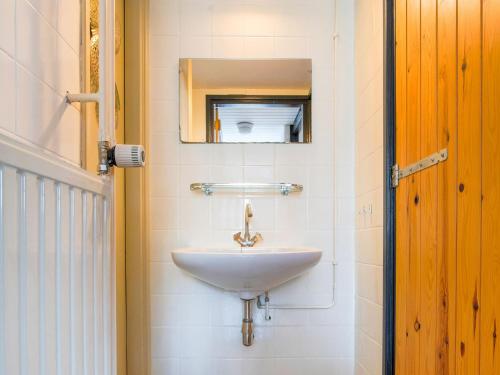 a bathroom with a sink and a mirror at Chalet in Ulestraten near Maastricht in Ulestraten