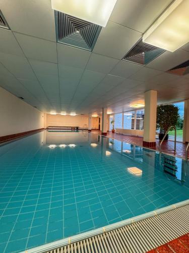 an empty swimming pool with blue tiles on the floor at Allgäutraum in Bolsterlang