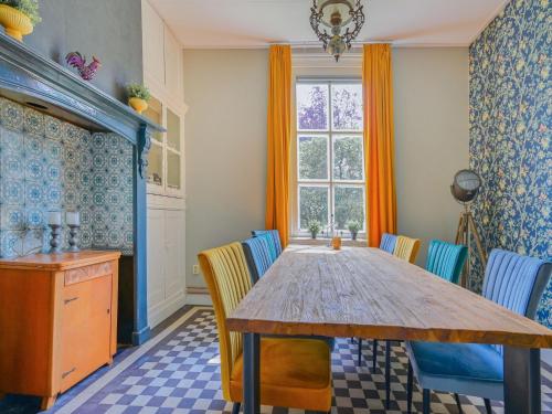 a dining room with a wooden table and chairs at Farmhouse in De Heurne near the forest in De Heurne
