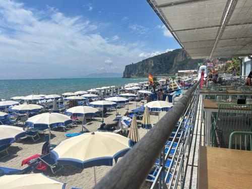 a group of umbrellas and chairs on a beach at Near the Sea in Finale Ligure