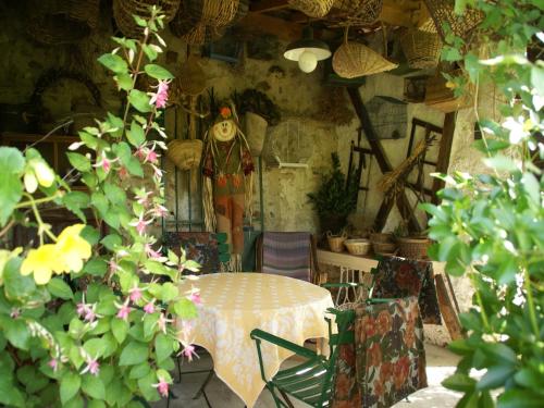 a table and chairs in a room with flowers at Charming Gîte in France for a Private Getaway in Mézy-Moulins