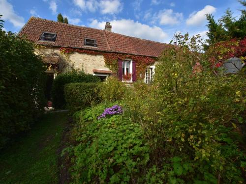 a brick house with a garden in front of it at Charming Gîte in France for a Private Getaway in Mézy-Moulins