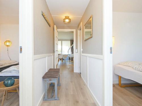 a hallway of a room with a bed and a table at 6 person holiday home in Ringkøbing in Ringkøbing