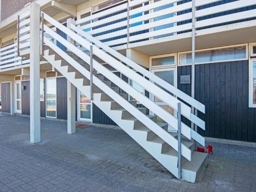 a white staircase in front of a building at 6 person holiday home in Ringkøbing in Ringkøbing