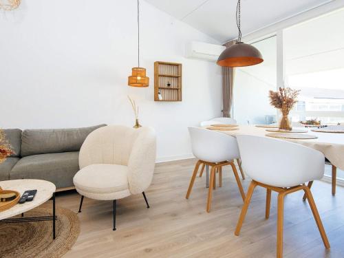 a living room with a couch and a table at 6 person holiday home in Ringkøbing in Ringkøbing