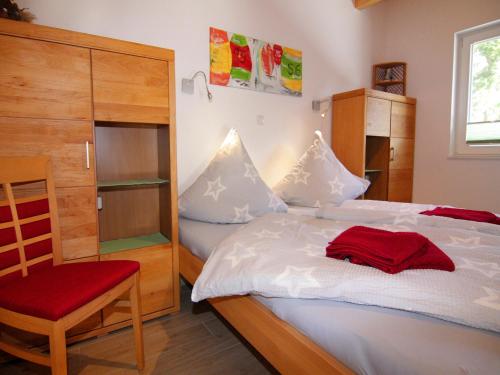 a small bedroom with a bed and a chair at Semi-detached house, Zingst in Zingst