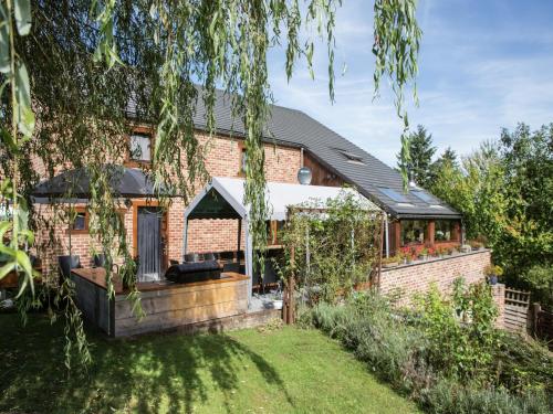 a brick house with a garden in front of it at Atmospheric holiday home in Durbuy with sauna in Septon