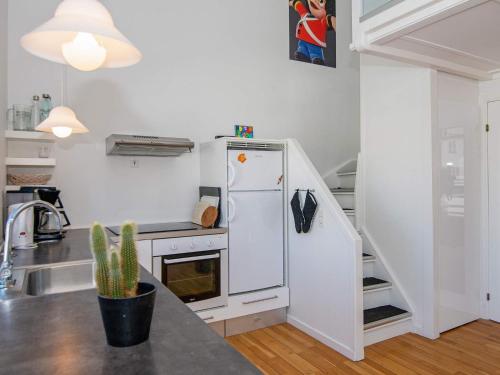 a kitchen with a white refrigerator and a sink at Holiday home on a holiday park in Ebeltoft in Ebeltoft