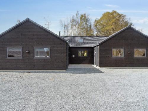 a brick house with a driveway in front of it at 5 star holiday home in Dronningmølle in Dronningmølle