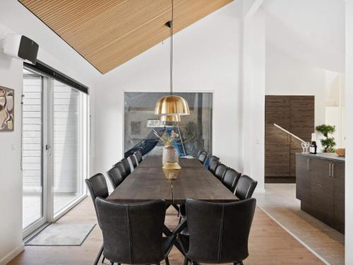 a dining room with a table and chairs at 5 star holiday home in Dronningmølle in Dronningmølle