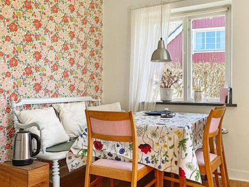 a dining room with a table and two chairs and a table and a tablecloth at 2 person holiday home in Brösarp in Brösarp