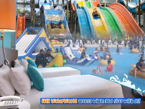 a large indoor water park with people in it at Wyndham Garden i-City Shah Alam in Shah Alam