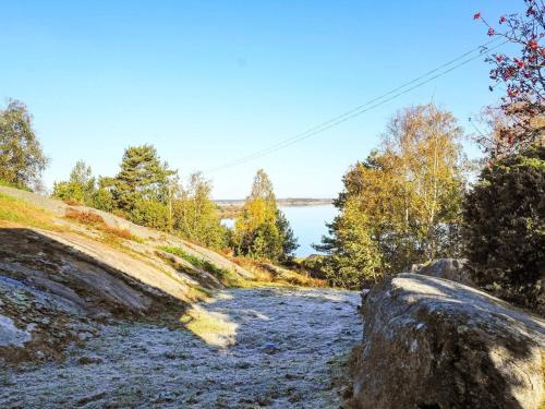 a dirt road next to a body of water at 5 person holiday home in KLÖVEDAL in Klövedal