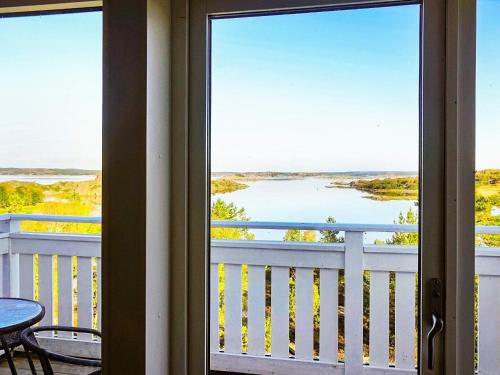 a balcony with a view of a lake from a house at 5 person holiday home in KLÖVEDAL in Klövedal