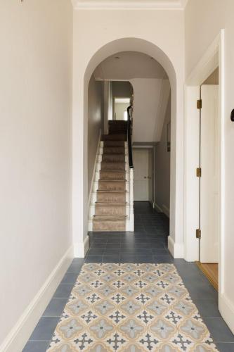 a hallway with a staircase with a rug on the floor at GuestReady - Modern haven with garden in Dublin in Dublin