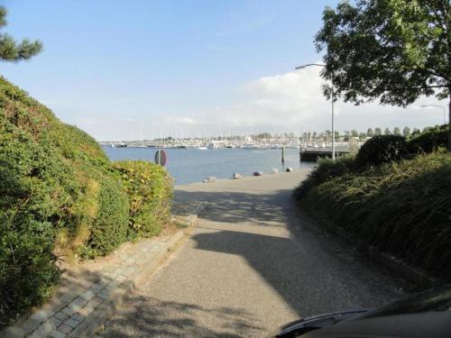 a path next to a body of water with a harbor at Luxury apartment in Résidence Marina Kamperland - pet friendly in Kamperland