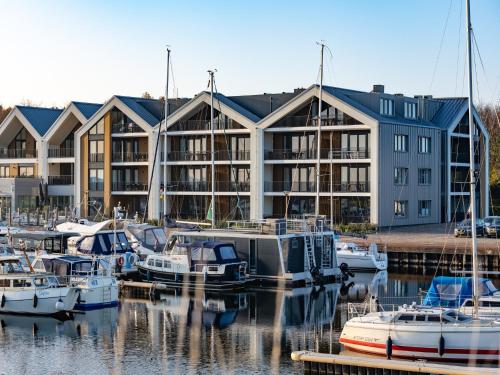 a group of boats docked in front of a building at Luxury apartment in Résidence Marina Kamperland - pet friendly in Kamperland
