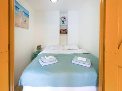 a bedroom with a bed with two towels on it at Vibrant Apartment in Baflo by Op de Roemte in Baflo