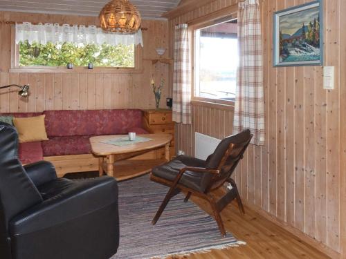 a living room with a couch and a table at 6 person holiday home in Vatne in Vatne