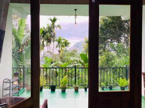 a room with a balcony with potted plants at Nest & Nook Ella in Ella