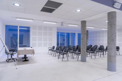 a conference room with chairs and a table and a podium at Hotel Canova Sport & Relax in Cavaso del Tomba