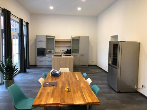 a large kitchen with a wooden table and chairs at Traumhafte Wohnung 4 Albersbach in Reichenbach-Steegen
