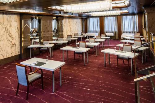a row of tables and chairs in a room at Gästehaus Sophienstraße in Stuttgart