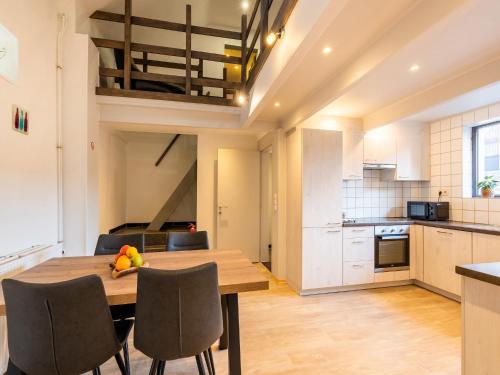 a kitchen and dining room with a wooden table and chairs at Herselt Garden Shed Retreat in Herselt