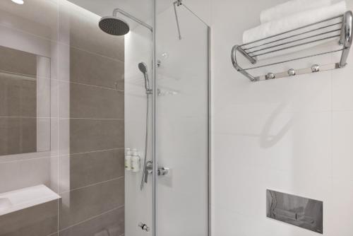 a shower with a glass door in a bathroom at B&B HOTEL Porto Centro Massarelos in Porto
