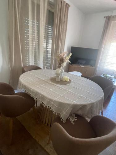 a dining room table with a white table cloth and chairs at La pause Saumuroise in Saumur