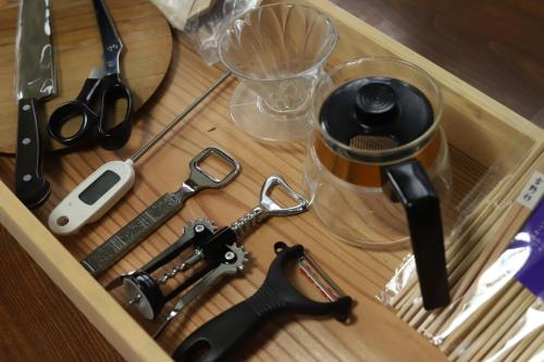 a drawer with a pair of scissors and other kitchen utensils at 柿畑の宿 guesthouse next to the persimmon orchard in Katsuragi