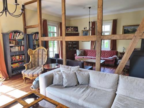 a living room with a couch and some chairs at Ferienhaus Dreamholiday - Stilvolles großes Ferienhaus mit Garten in Mittelhof