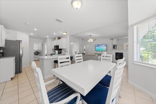 a kitchen and dining room with a white table and chairs at Tranquil Haven - Pet Friendly in Perdido Key