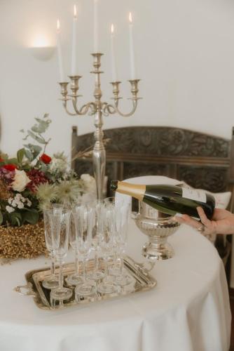 a person pouring a glass of wine on a table at Landhotel Stähle in Schüttorf